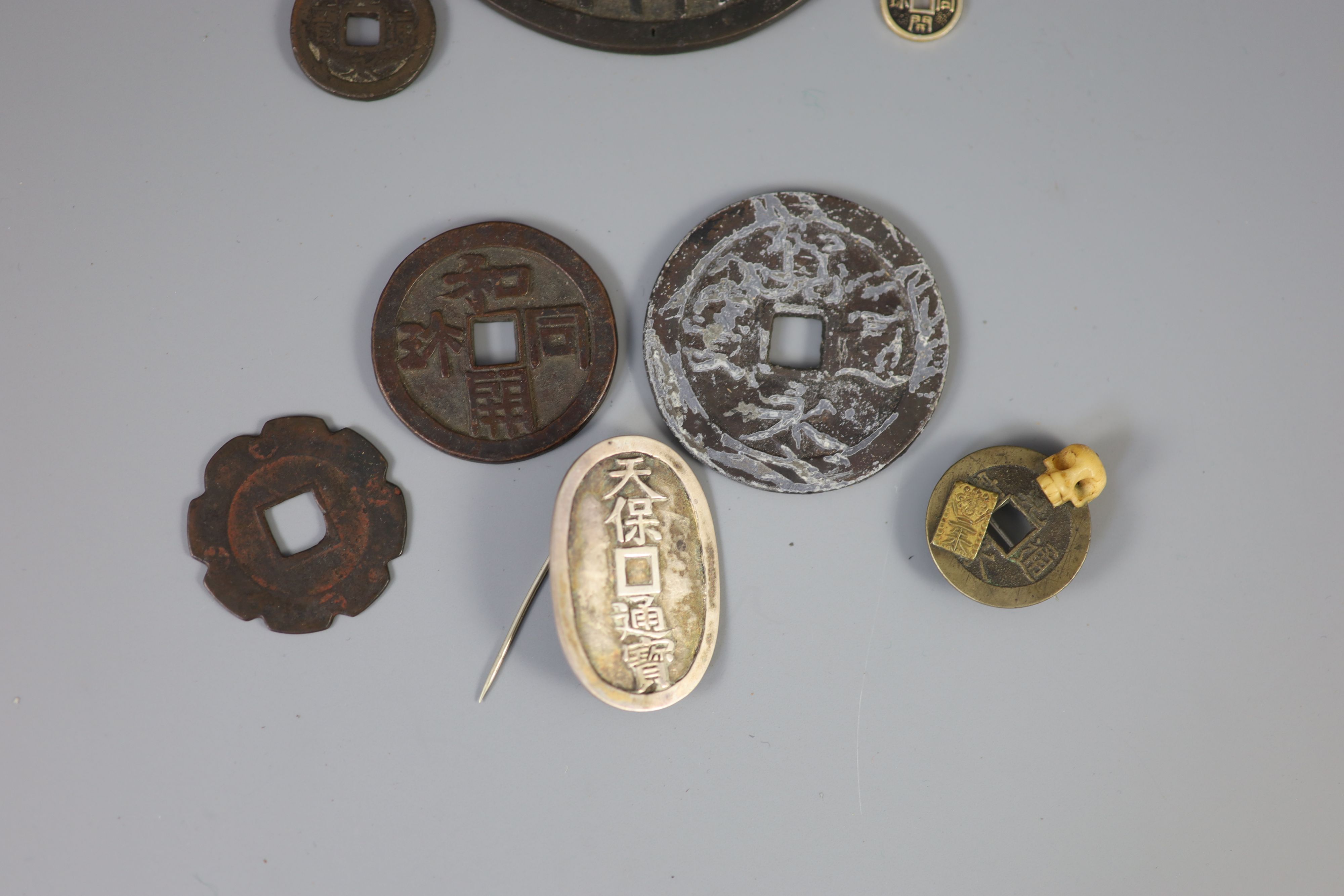 A group of Japanese bronze coin charms or amulets, 19th/20th century,